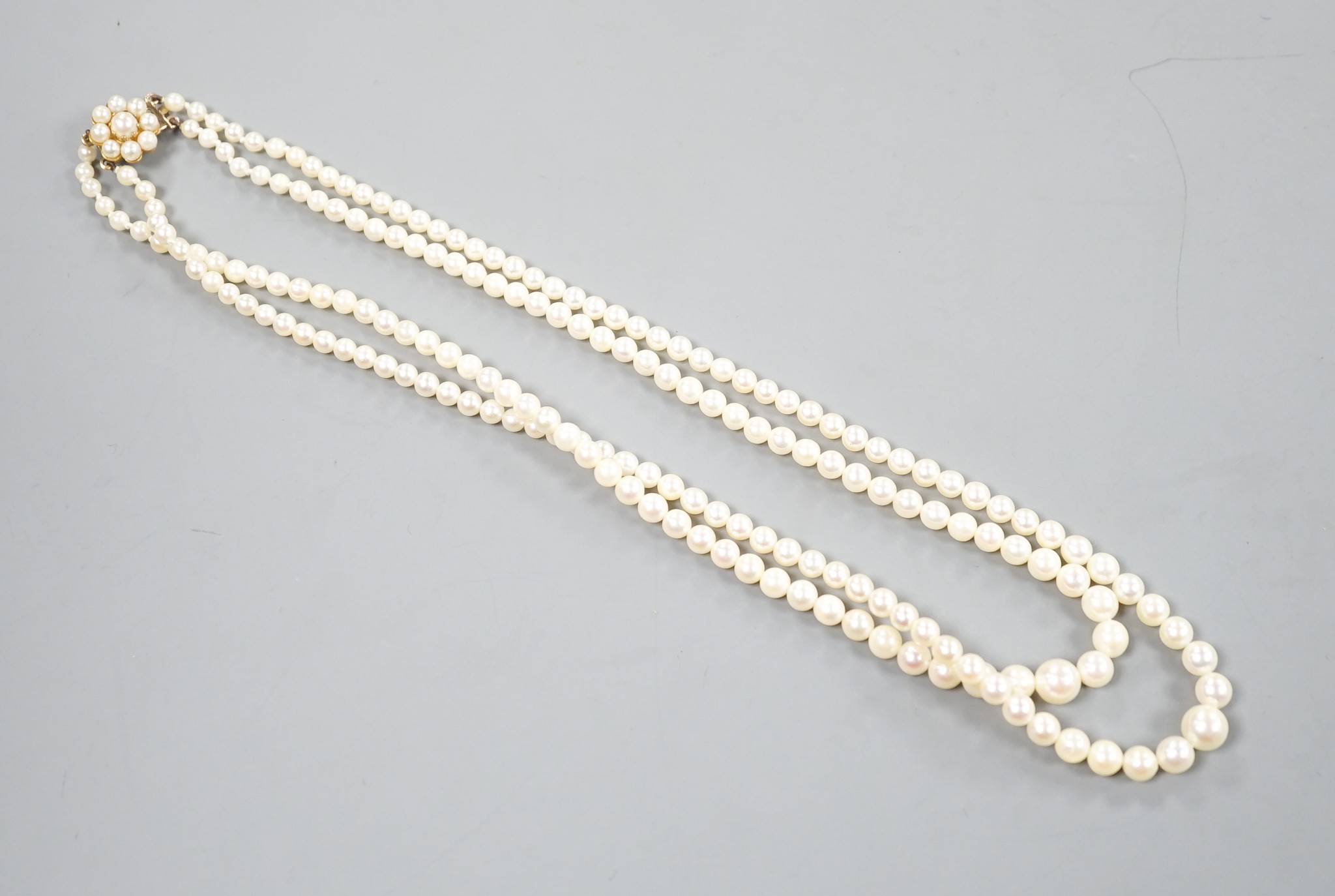 A double strand graduated cultured pearl necklace, with a 9ct and cultured pearl set clasp, 44cm.